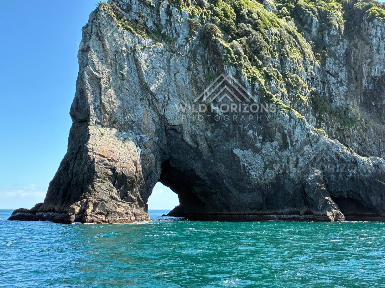 Sheer Cliffs Framing the Hole in the Rock. Bay of Islands, New Zealand