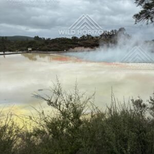 Steam Rising Over a Mineral-Stained Lake. Wai-O-Tapu, Rotorua, New Zealand