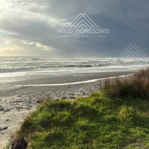 Storm Light Over a Pebble Beach. Hokitika, New Zealand.