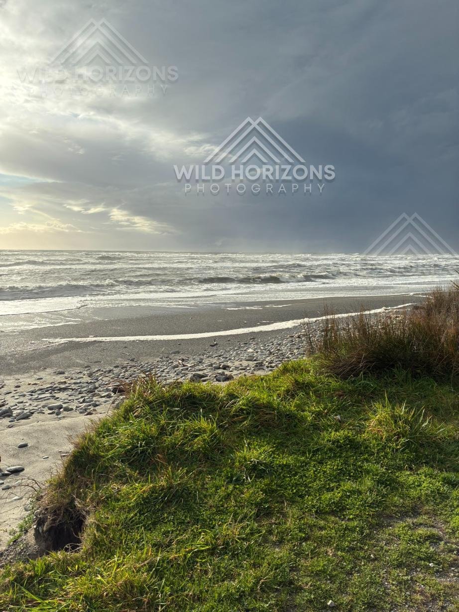 Storm Light Over a Pebble Beach. Hokitika, New Zealand.