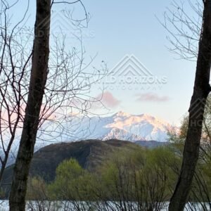 Framed Alpenglow over the Southern Alps from Glendhu Bay, Lake Wānaka, New Zealand.