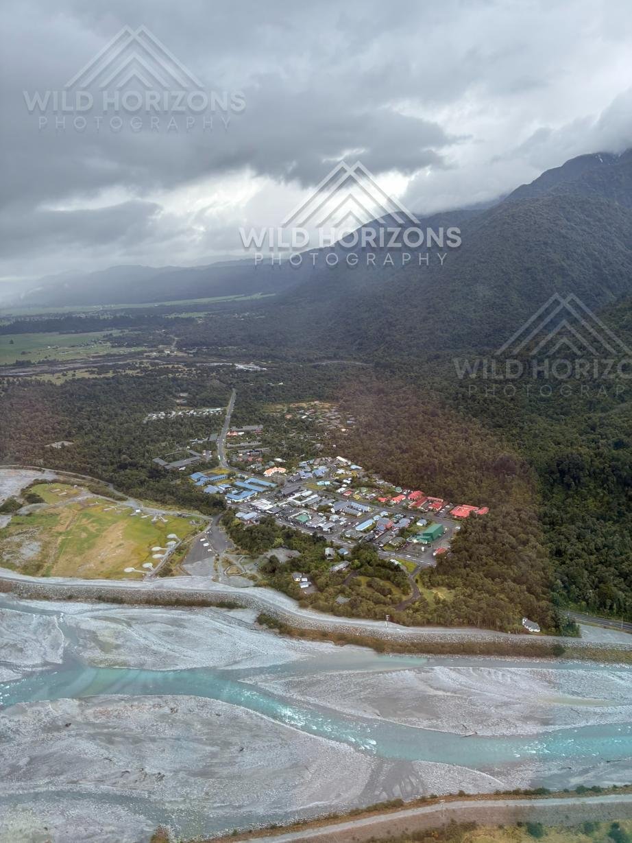 Aerial view of Franz Josef town beside braided river channels. Franz Josef, New Zealand