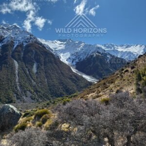 Glacier-fed alpine valley beneath sharp snow-covered peaks. Aoraki / Mount Cook National Park, New Zealand
