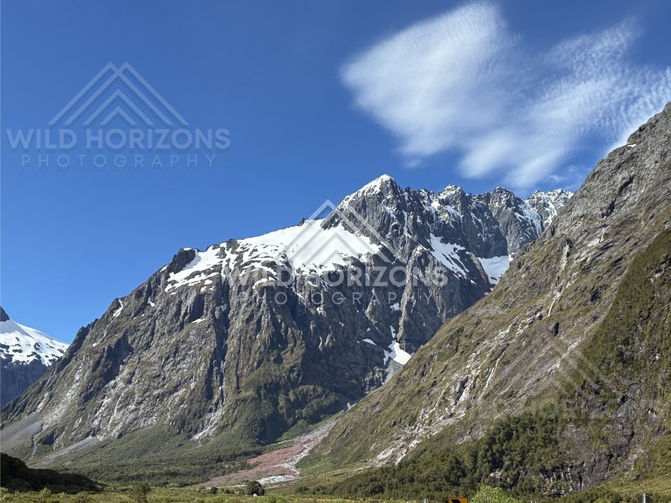 Snow-Capped Peaks and Sheer Rock Faces in a Fiordland Valley, Milford Road, New Zealand
