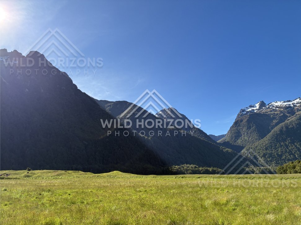 Open Fiordland Meadow Between Steep Mountains, Milford Road, New Zealand