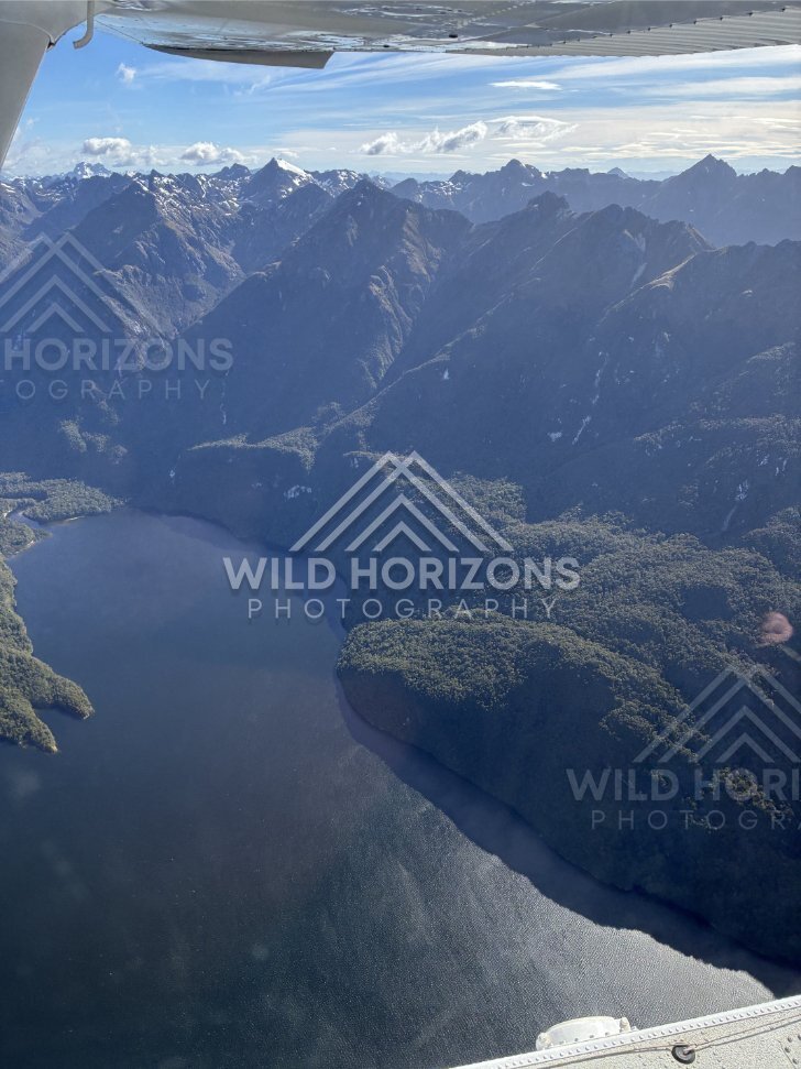 Seaplane Window View Over a Fiordland Lake and Mountain Walls, Fiordland National Park, New Zealand