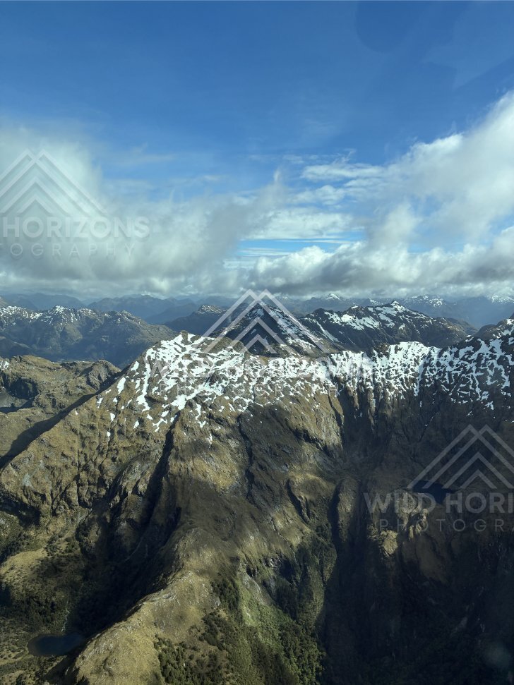 Aerial View of Rocky Fiordland Peaks and a Hidden Tarn, Fiordland National Park, New Zealand
