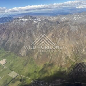 Aerial view of the jagged peaks of the Remarkables range under scattered cloud. The Remarkables, New Zealand