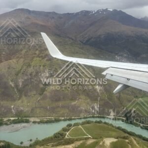 Aerial perspective of the Kawarau River flowing between rugged hillsides. Kawarau Gorge, New Zealand