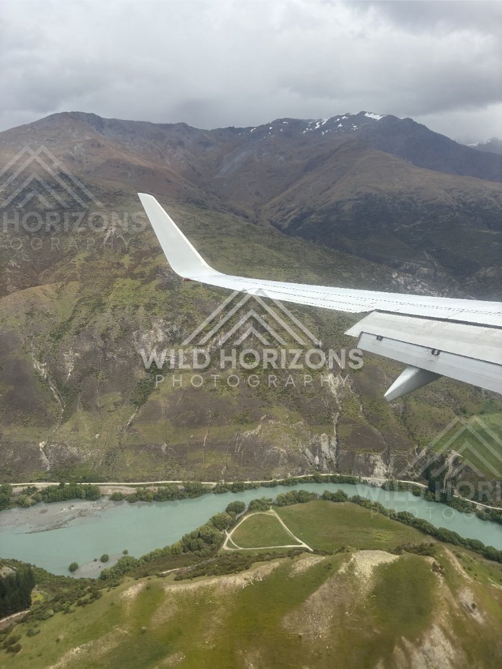 Aerial perspective of the Kawarau River flowing between rugged hillsides. Kawarau Gorge, New Zealand