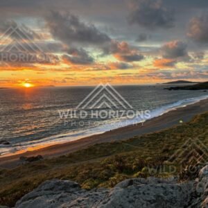 Dramatic Sunset Clouds Over a Southland Beach with Tiny Figures for Scale. Riverton, New Zealand