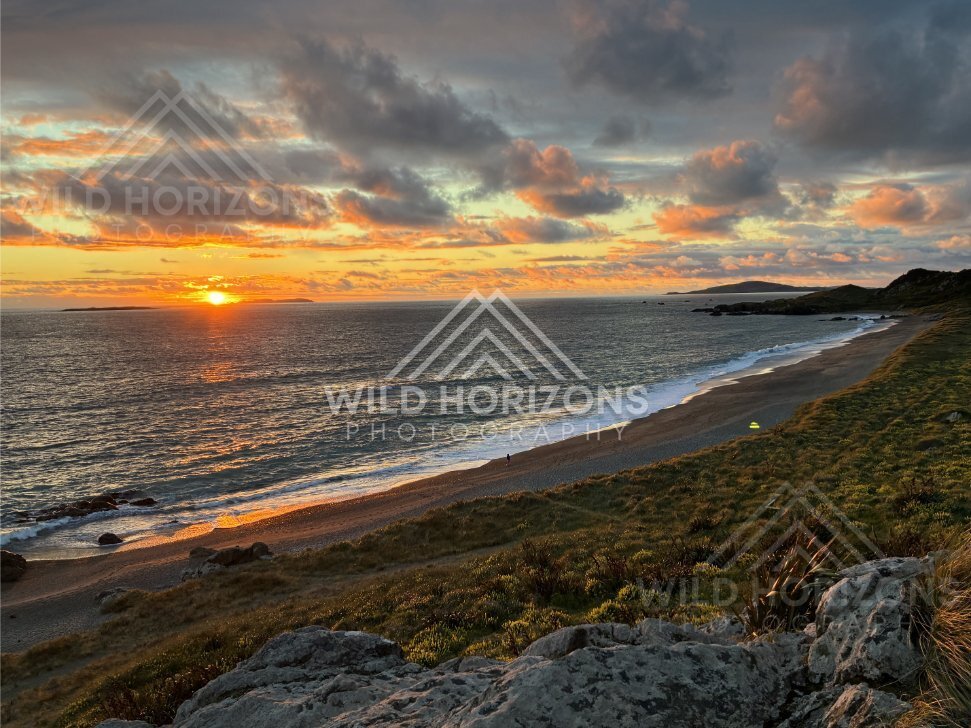 Dramatic Sunset Clouds Over a Southland Beach with Tiny Figures for Scale. Riverton, New Zealand