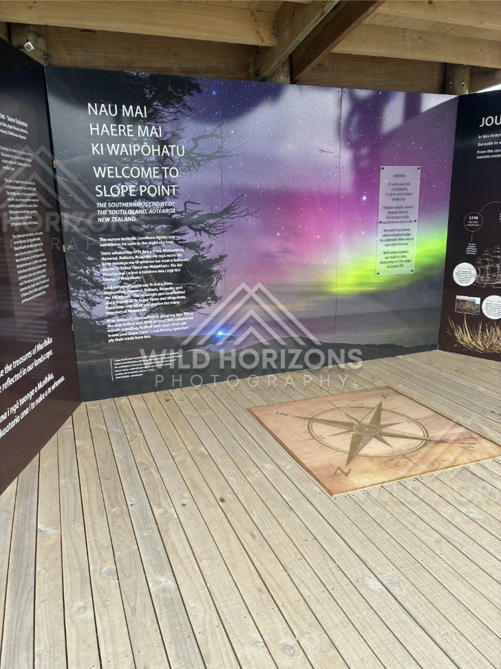 Welcome display at the southernmost point with aurora artwork. Slope Point, New Zealand