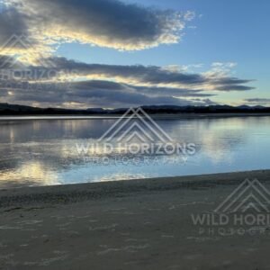 Soft evening light shimmering across calm tidal flats. Surat Bay, New Zealand