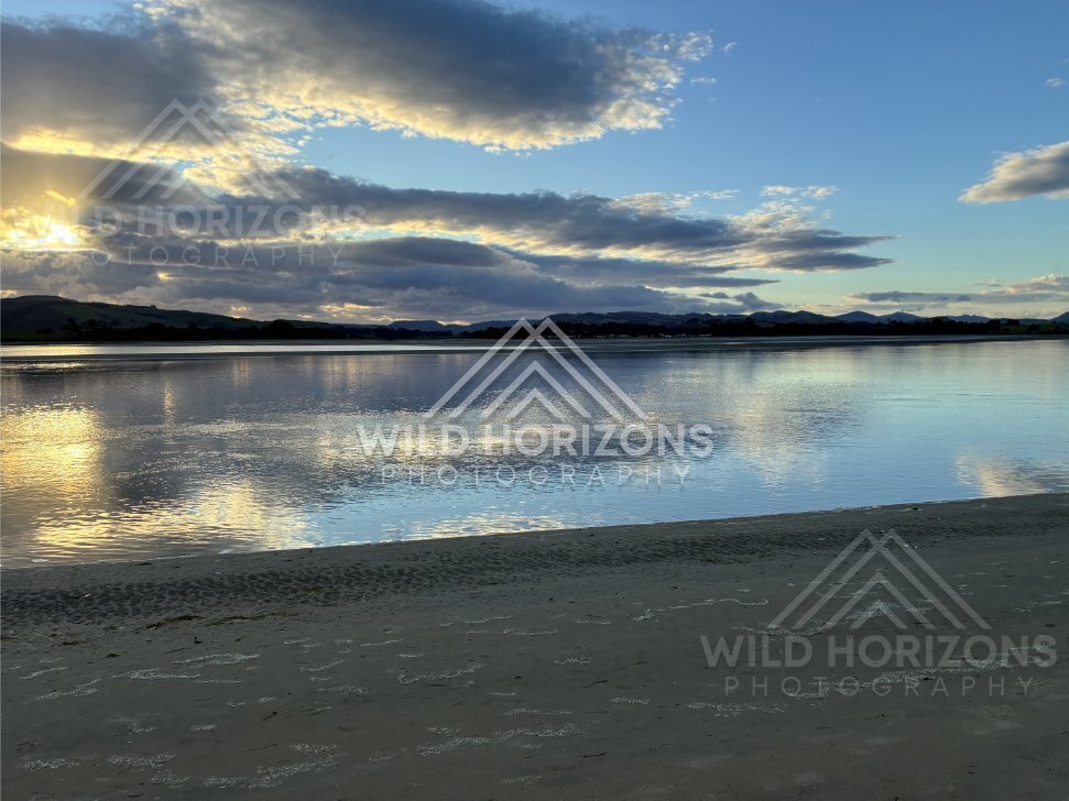 Soft evening light shimmering across calm tidal flats. Surat Bay, New Zealand