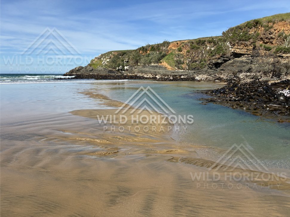 Scattered Rocks on Sandy Beach, The Catlins, New Zealand