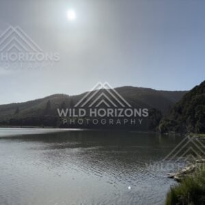 Wide Lake with Forested Hills and Distant Building, Taieri River, New Zealand
