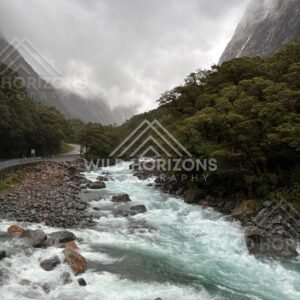 Turquoise rapids and storm cloud valley on Milford Road, New Zealand