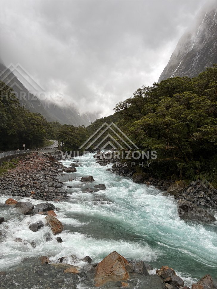Turquoise rapids and storm cloud valley on Milford Road, New Zealand