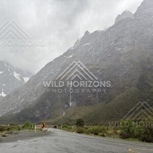 Roadside bend under sheer Fiordland cliffs on Milford Road, New Zealand
