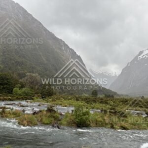 Braided river flats between Fiordland mountains on Milford Road, New Zealand