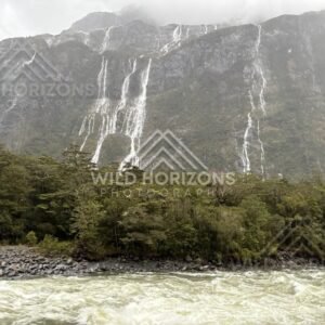 Rain-fed waterfalls above a Fiordland river, Milford Road, New Zealand