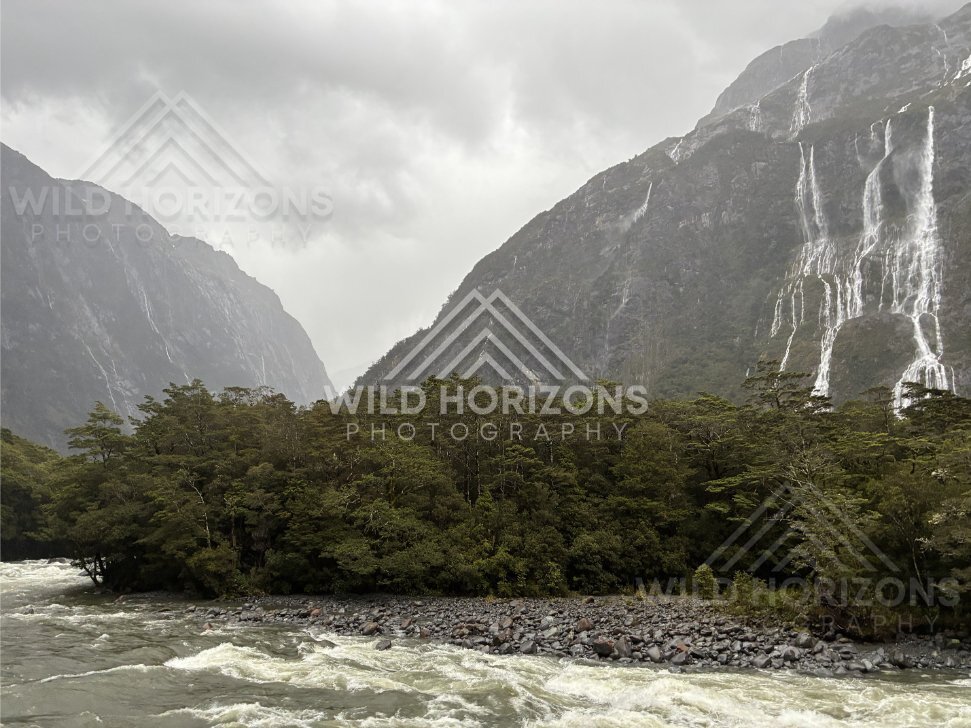 Fiordland valley and waterfalls in stormy weather, Milford Road, New Zealand