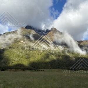 Sunlit alpine valley along the Milford Road, New Zealand