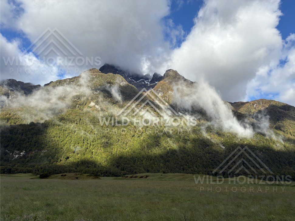 Sunlit alpine valley along the Milford Road, New Zealand