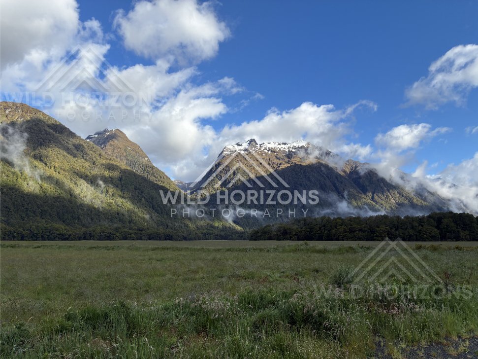 Cloud-draped mountain slopes beside the Milford Road, New Zealand