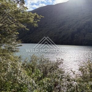 Open Fiordland valley under dramatic skies, Milford Road, New Zealand