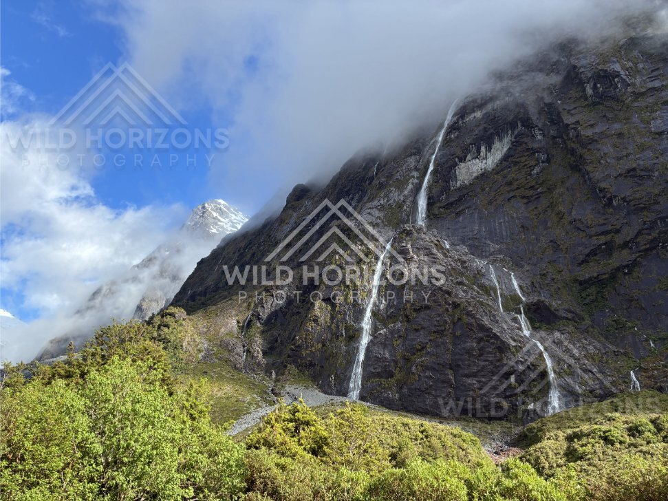 Fiordland Cliff Waterfalls with Mist and Snow Peak, Milford Road, Fiordland National Park, New Zealand