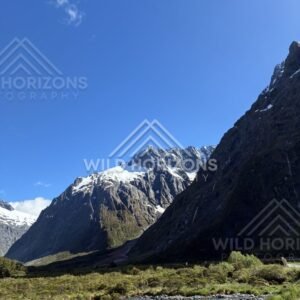 Vertical View of River and Snowy Fiordland Peaks, Milford Road, Fiordland National Park, New Zealand