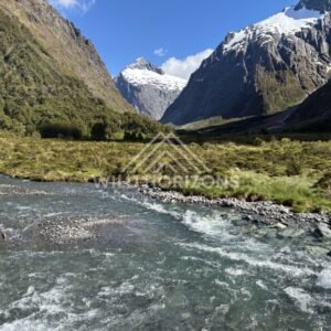 River Bend Leading into a Snowy Fiordland Pass, Milford Road, Fiordland National Park, New Zealand