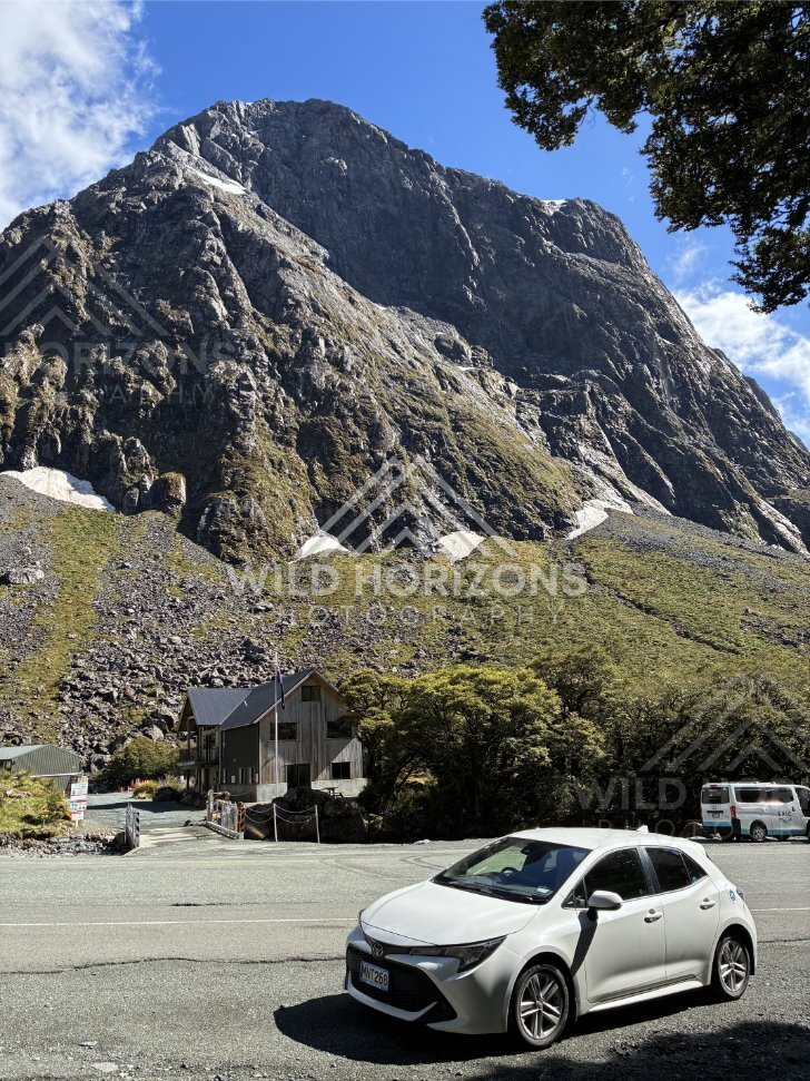 Mountain Lodge and Car beneath a Massive Fiordland Peak, Milford Road, Fiordland National Park, New Zealand