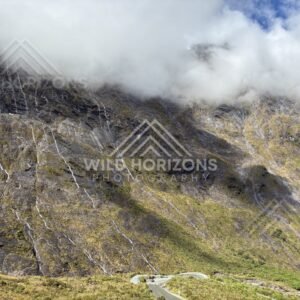 Winding Milford Road Under Cloudy Peaks and Waterfall Streaks, Milford Road, Fiordland National Park, New Zealand