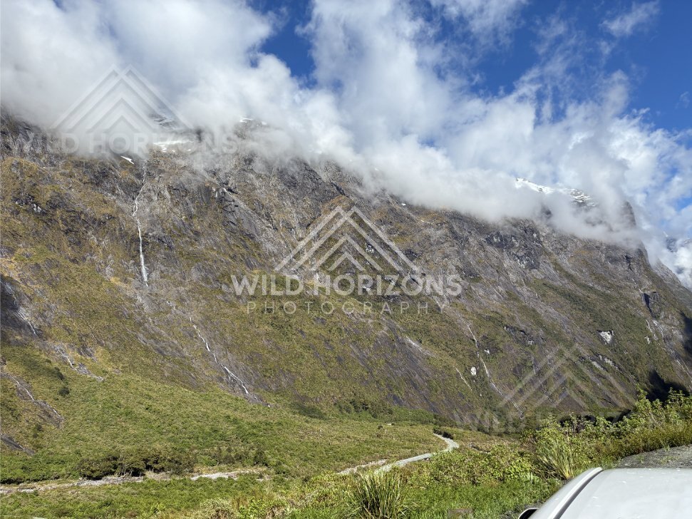 Alpine Valley with Lifting Cloud and Distant Snow Patches, Milford Road, Fiordland National Park, New Zealand