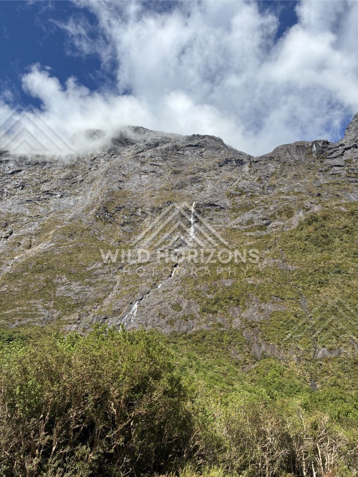 Steep Cliff Waterfall Under Breaking Cloud, Milford Road, New Zealand