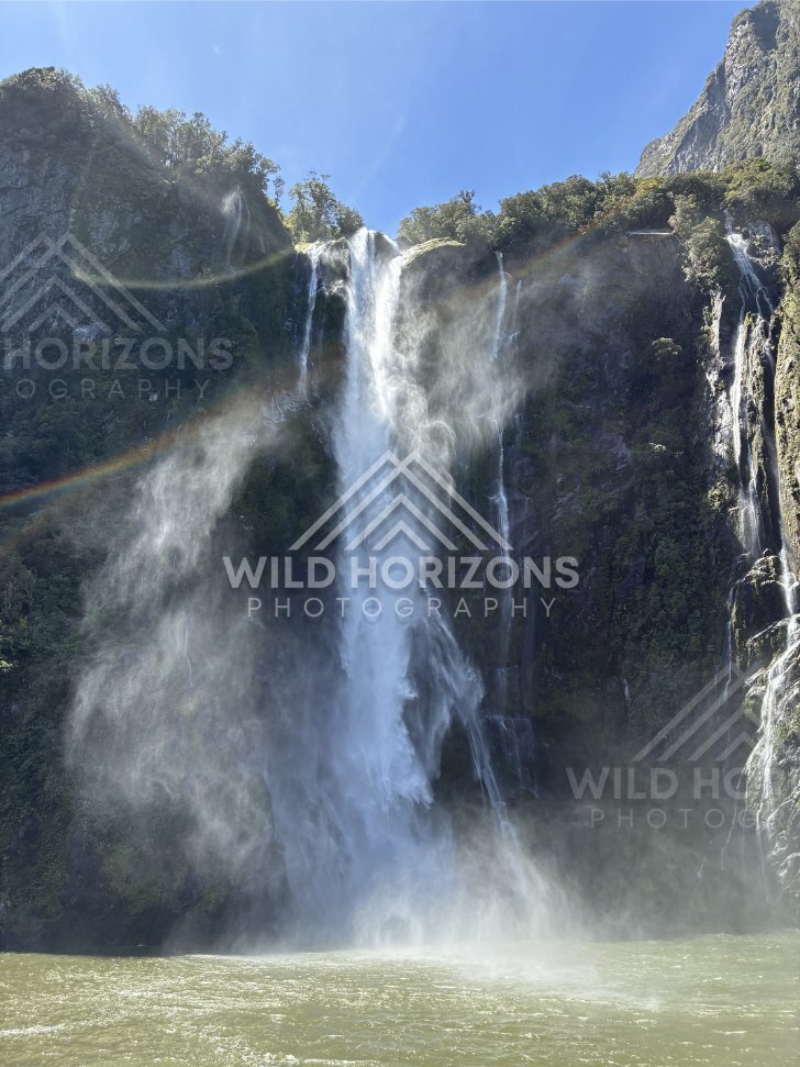 Waterfall mist with a faint rainbow, Milford Sound, New Zealand