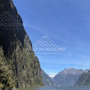 Fjord panorama with sheer cliff and distant peaks, Milford Sound, New Zealand