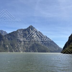 Jagged peak above calm fjord waters, Milford Sound, New Zealand