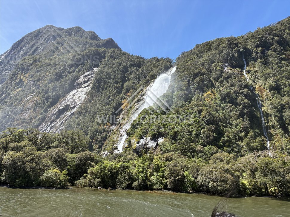 Diagonal cascade and twin falls on Fiordland hillside, Milford Sound, New Zealand