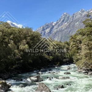 Glacial Stream Flowing Toward Snow-Capped Peaks. New Zealand