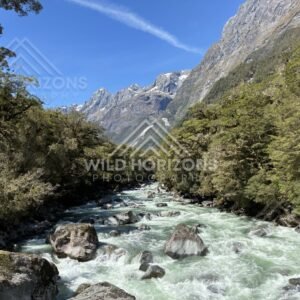 Mountain River Under Clear Sky and High Ridge. New Zealand