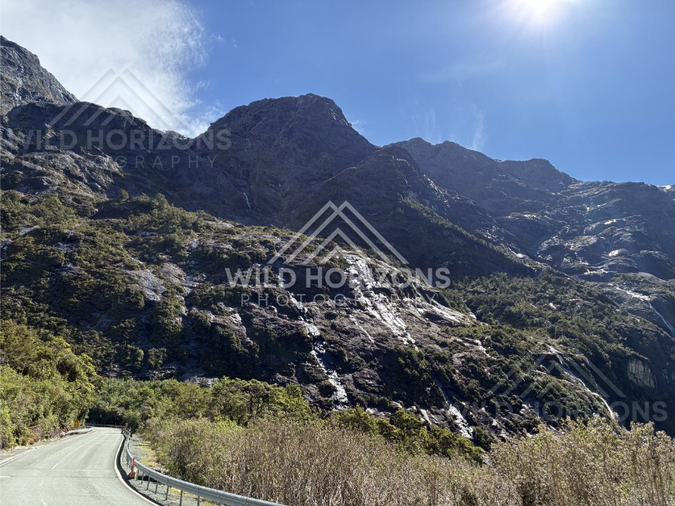 Mountain Road Curving Beneath Steep Rocky Slopes. New Zealand