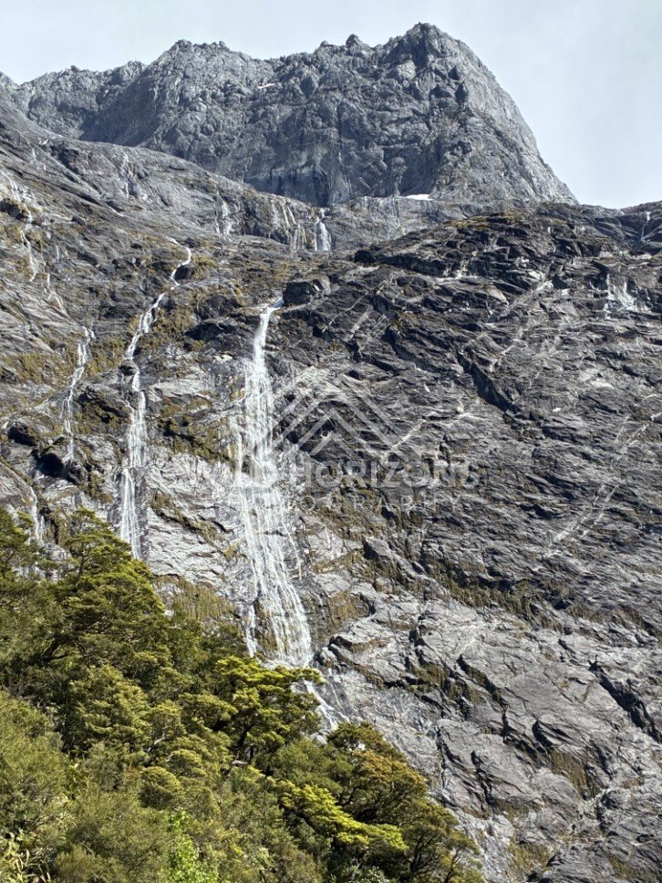 Waterfalls on Steep Cliffs Along Milford Road New Zealand