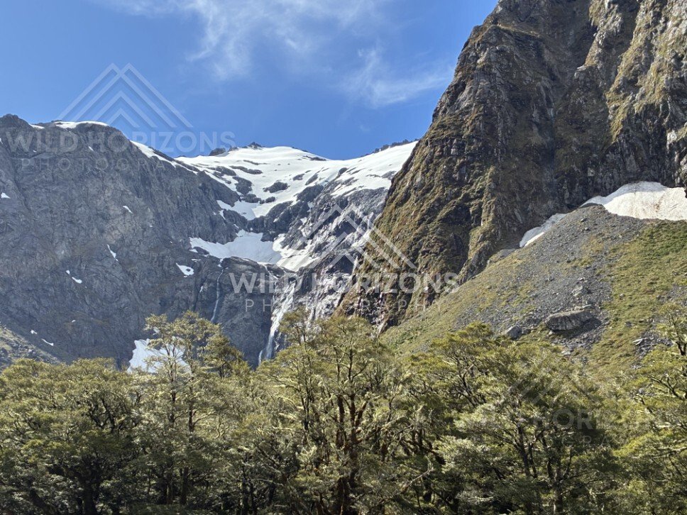 Mountain Valley and Snow Patches Along Milford Road New Zealand