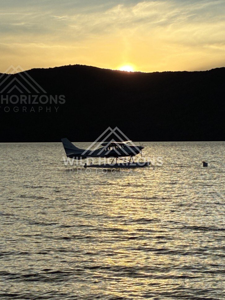 Seaplane Silhouette on Lake Te Anau at Sunset New Zealand