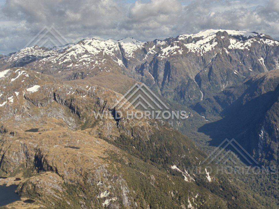 Sunlit Fiordland Ranges and Deep Valleys. Fiordland, New Zealand.