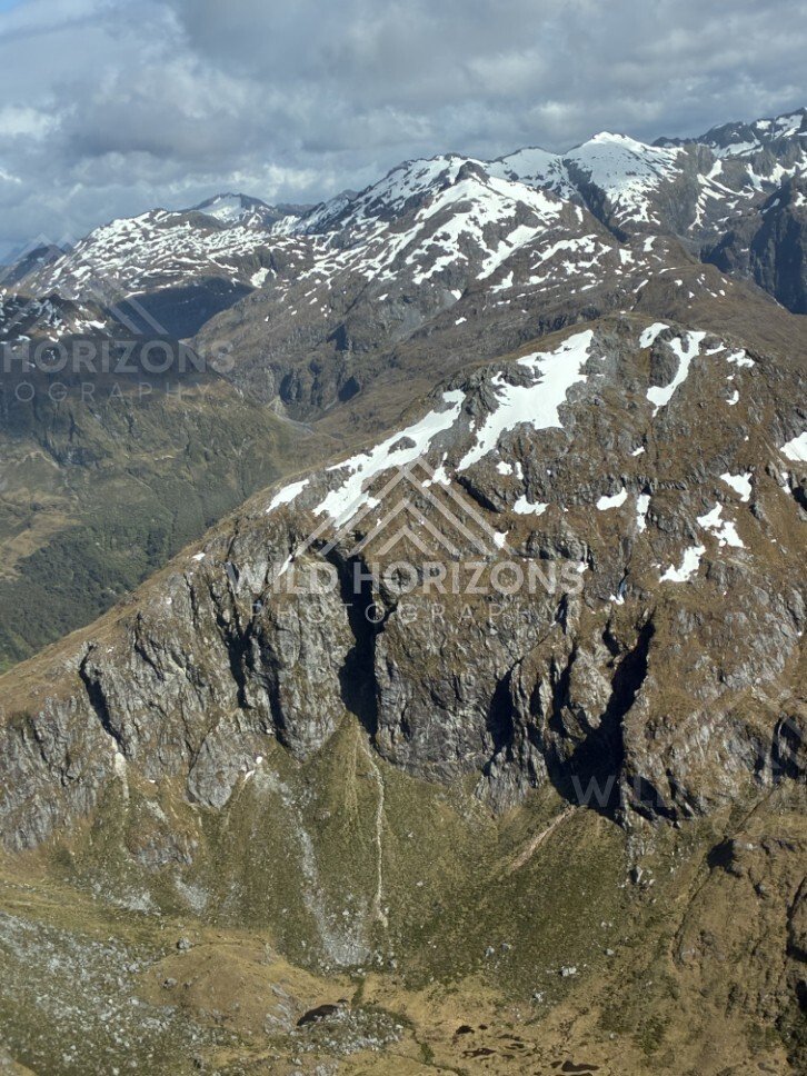 Jagged Fiordland Peaks and Snow Patches. Fiordland, New Zealand.